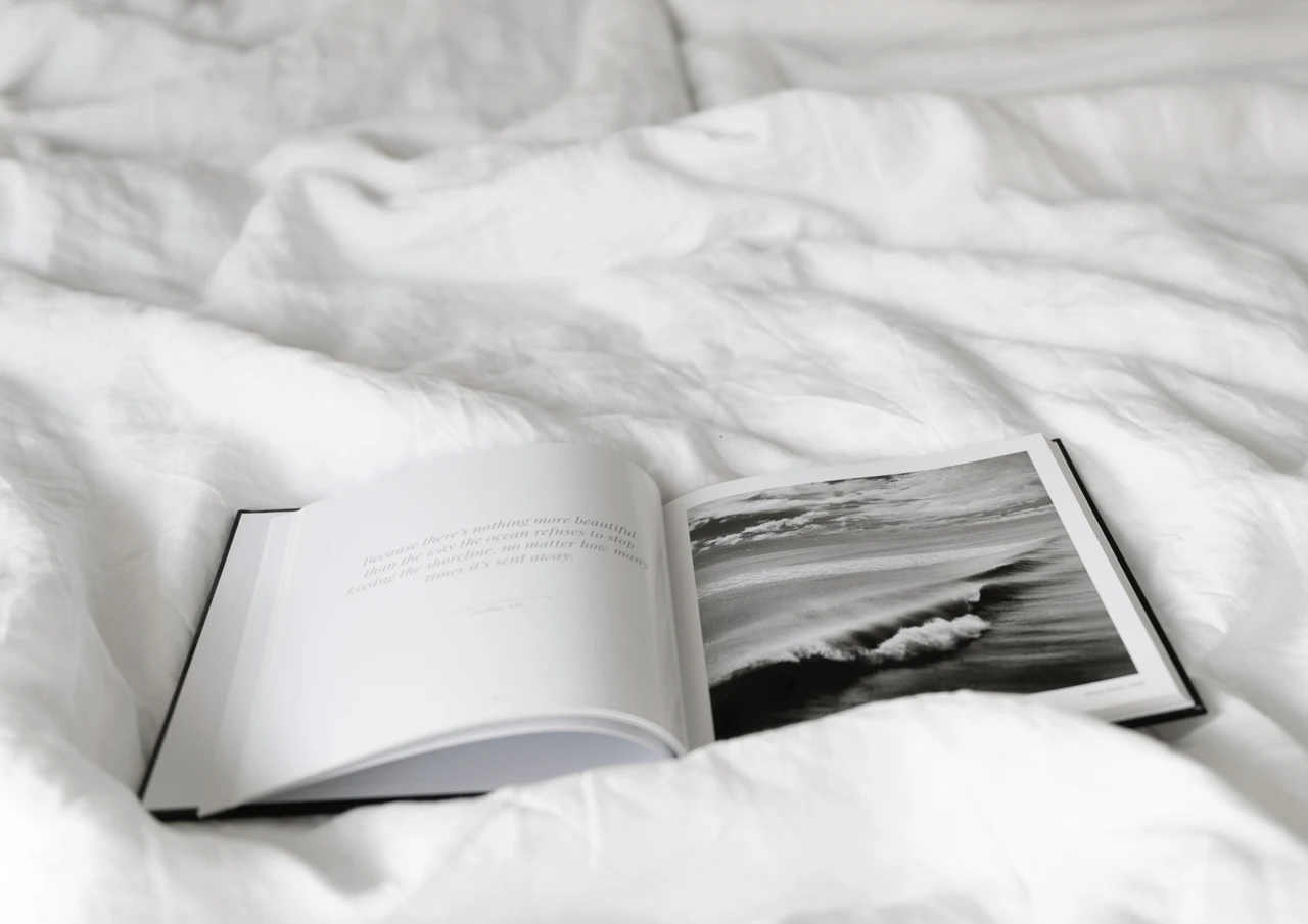 Black and white book on a bed cover