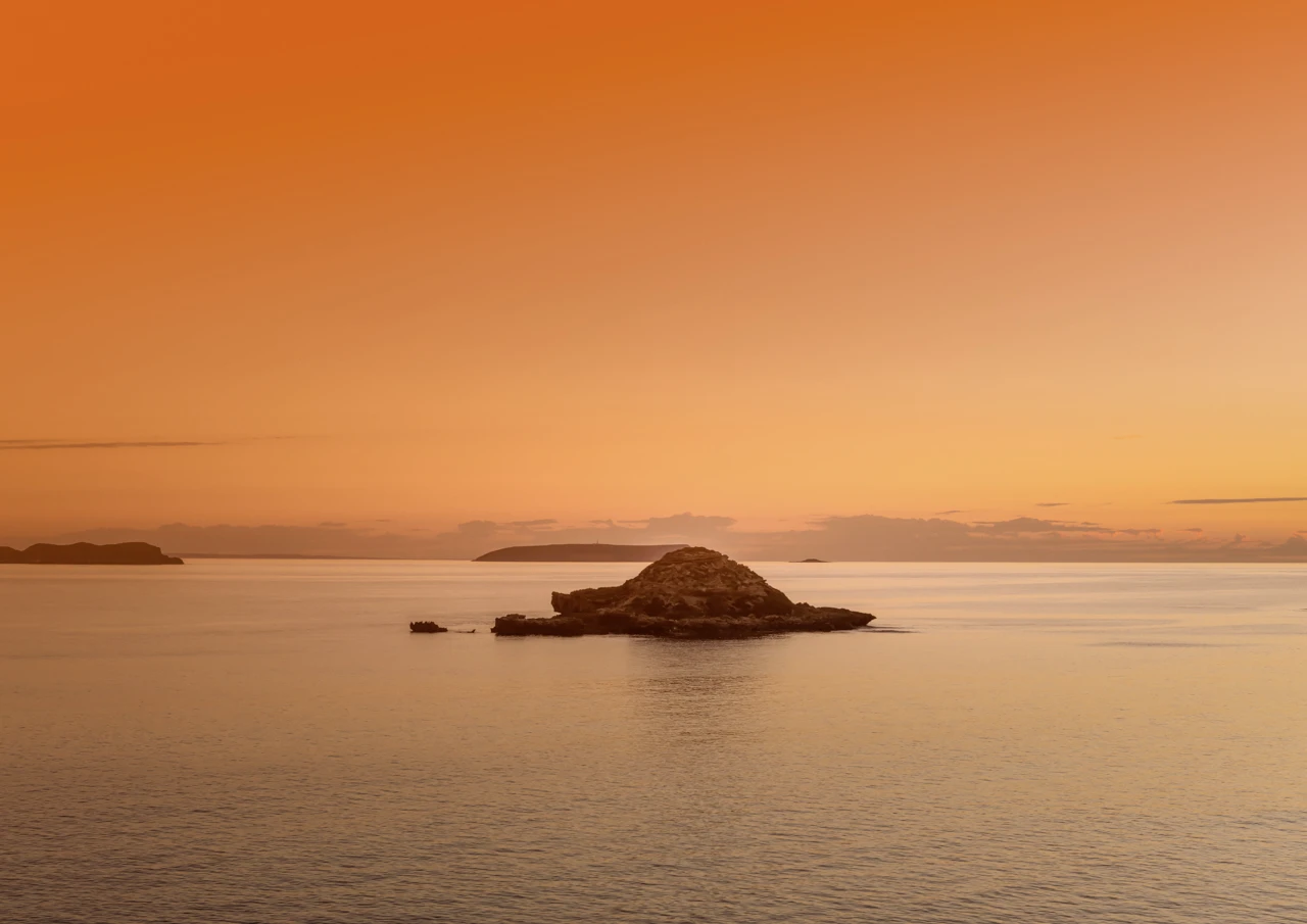 Chinamans Hat Island with a radiant sunset