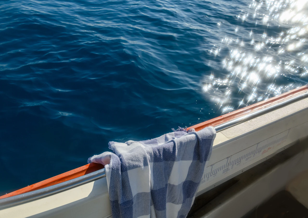 Out at sea, blue towel