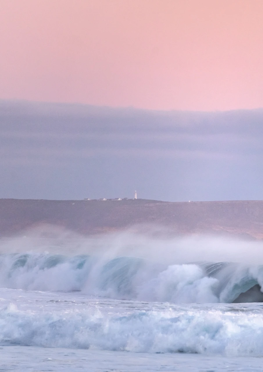 pink sunset and a distant lighthouse