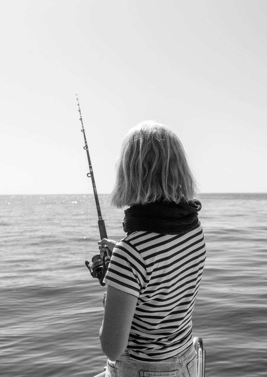 Girl fishing in black and white