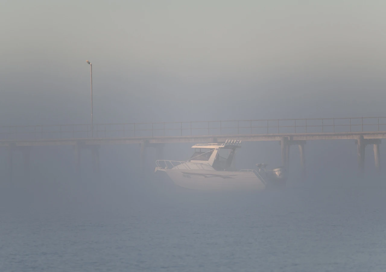 Foggy fishing day Fishing boat in the fog