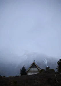 An A framed house in the fog in the mountains in New Zealand