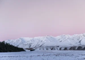 Pink sky over some snowy mountains