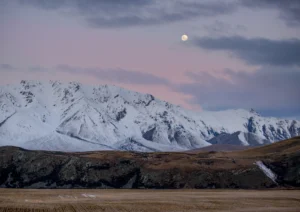 Mountains and the moon showing through