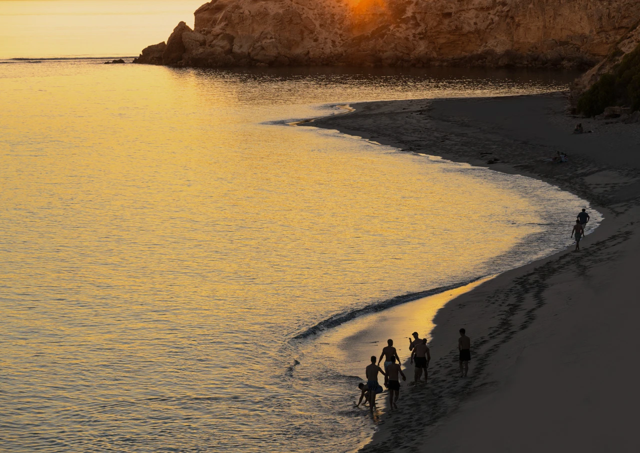 Teenagers walking on the beach till dark At the beach till midnight