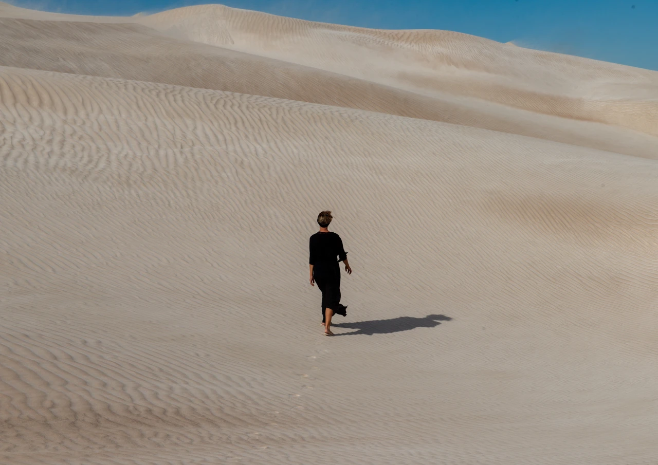Wendy Philip walking in Cactus beach sand dunes