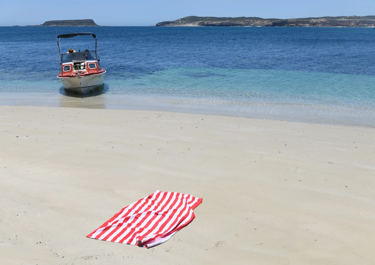 Boat and striped beach towel