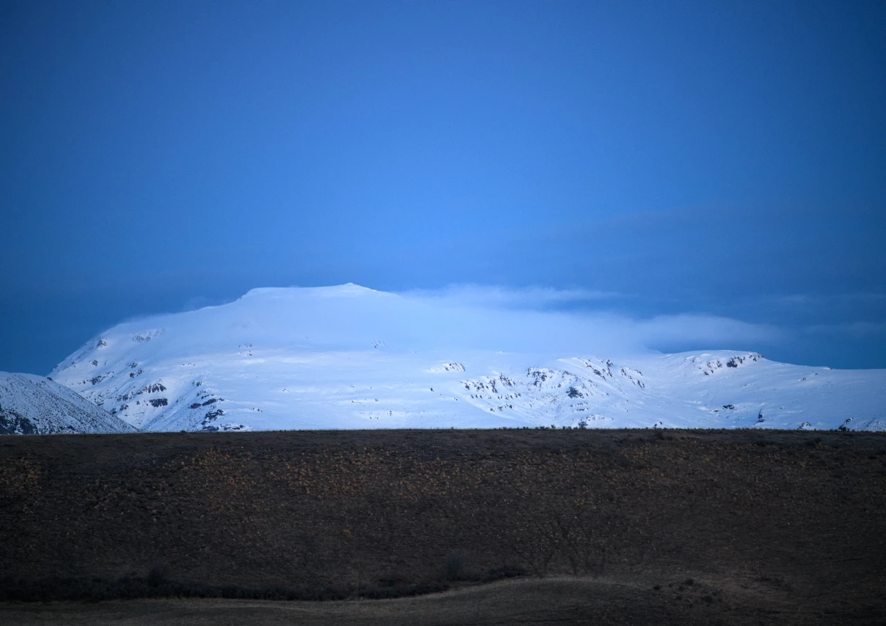 White clouds over snowy mountains New Zealand