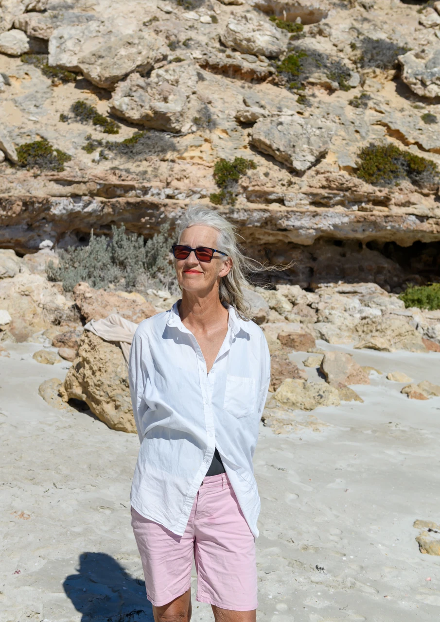 Wendy Philip stands next to the bank at Lizards beach Standing on the beach selfie