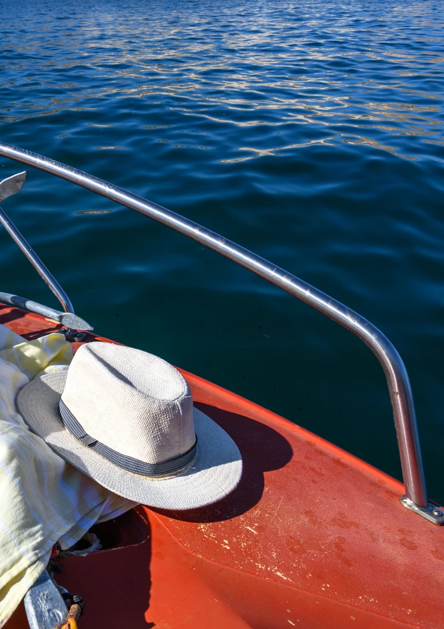 Red front of the boat and a sun hat