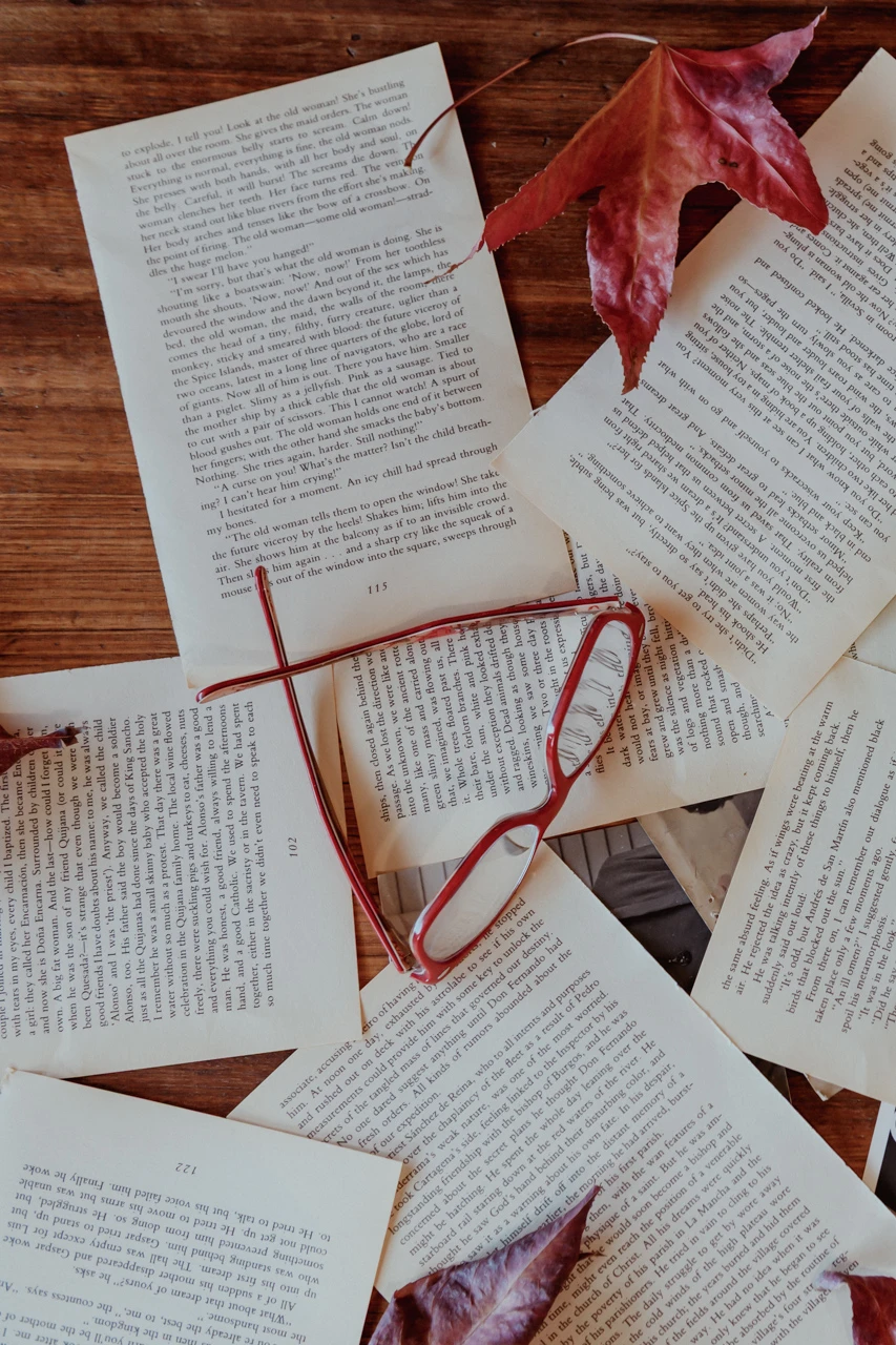 Red glasses on some papers