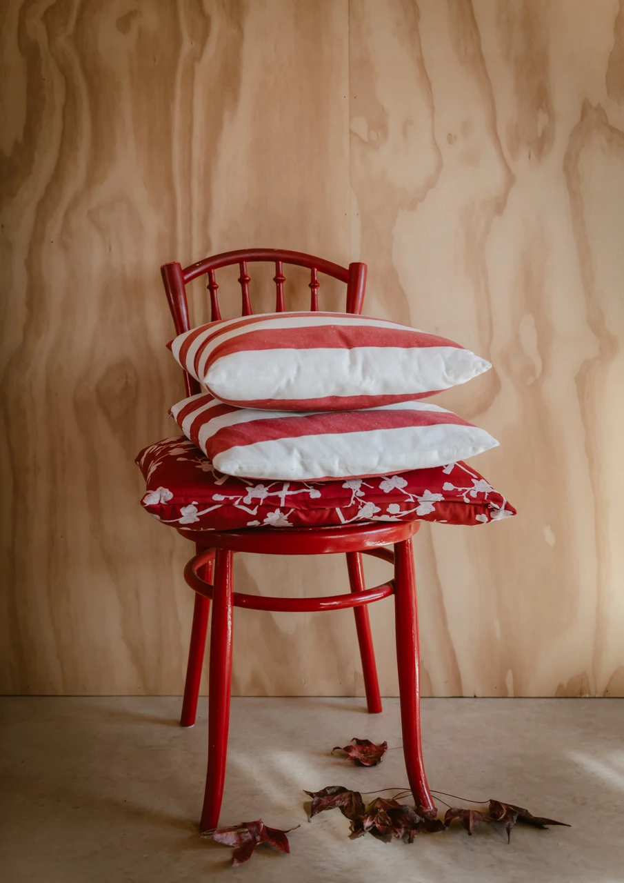 Red chair and pile of red cushions