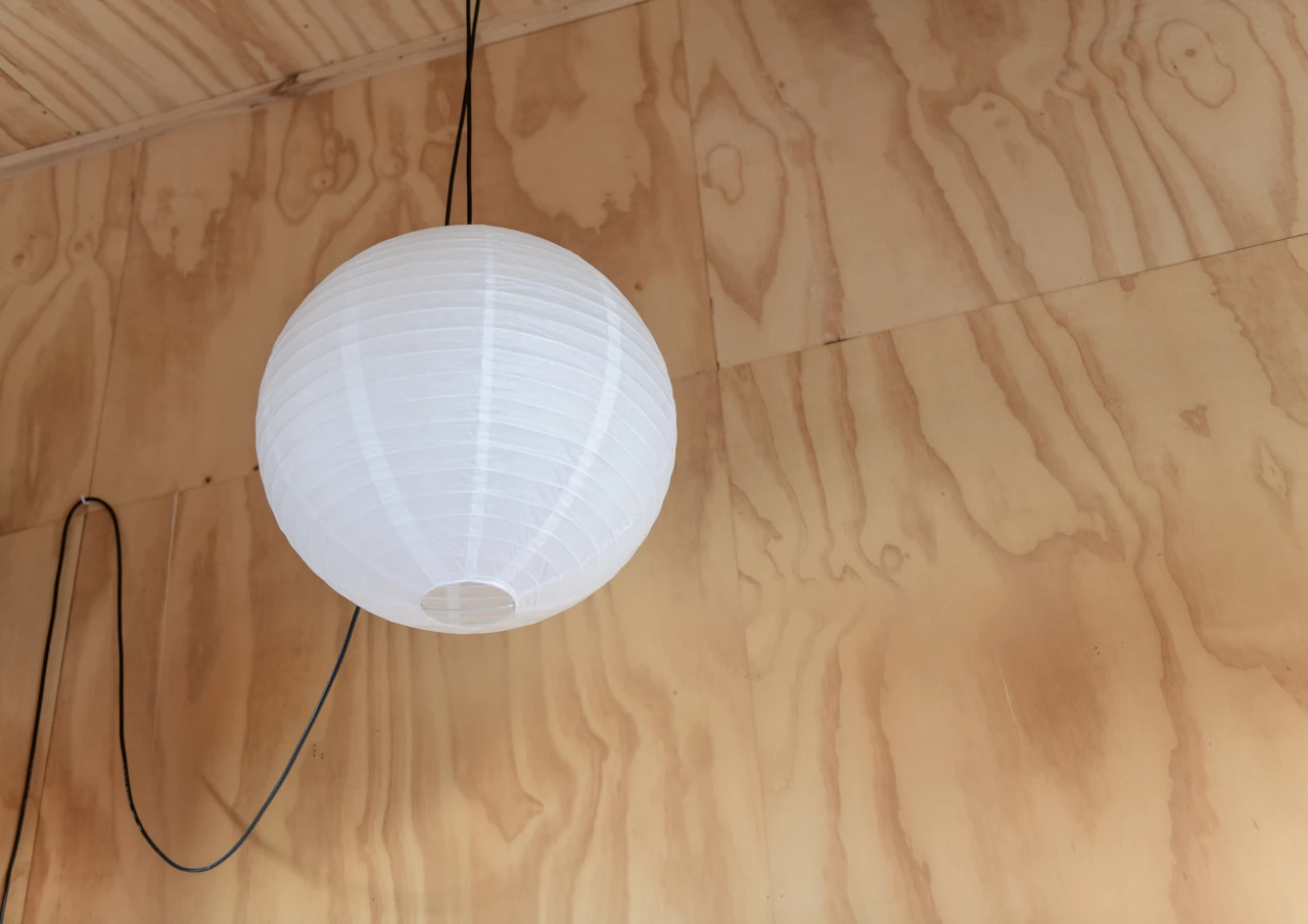 White paper ball lamp shade and wooden walls
