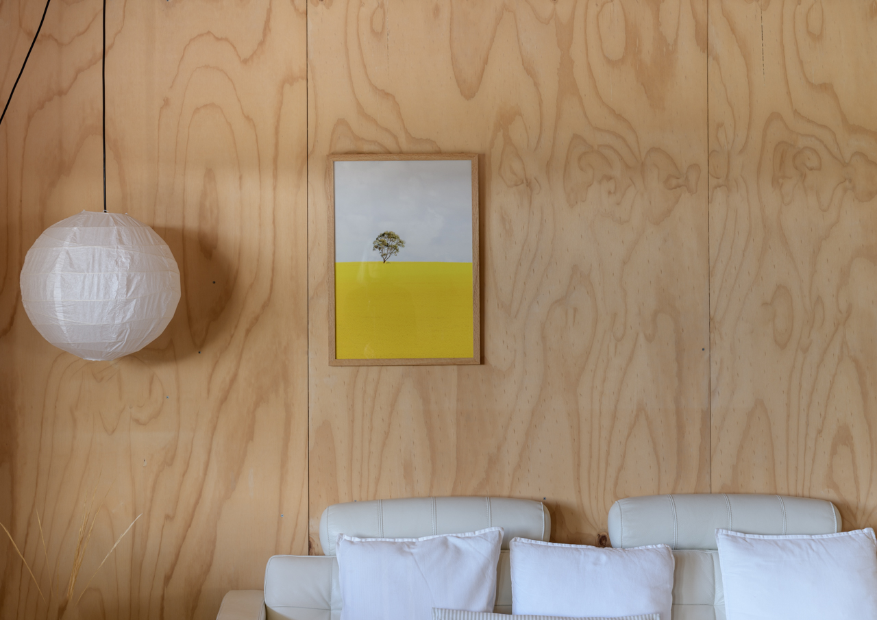 Yellow print and wooden walls lounge room