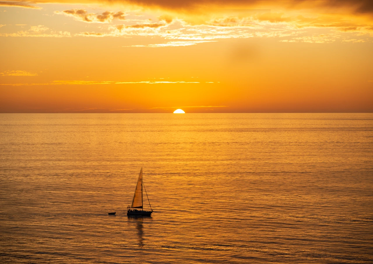 Yacht sails by Hallett Cove beach