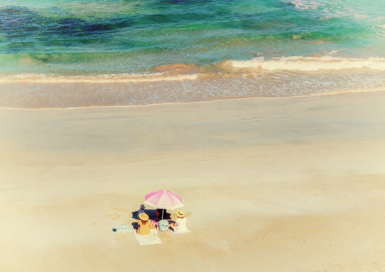 Girls under pink umbrella Girls on beach under pink umbrella vintage style