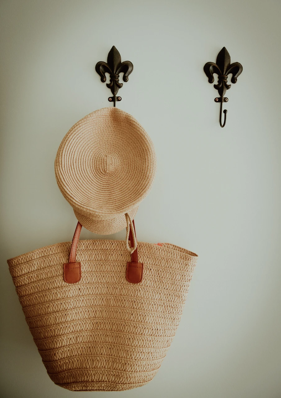 Hall with straw bag and hat hall pegs with hat and bag hanging, vintage style