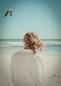 Girl with hair blowing in the wind, at the beach