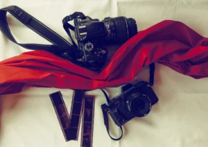 Two camera's and a splash of red material