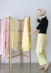 Woman in yellow pants and clothes drying rack