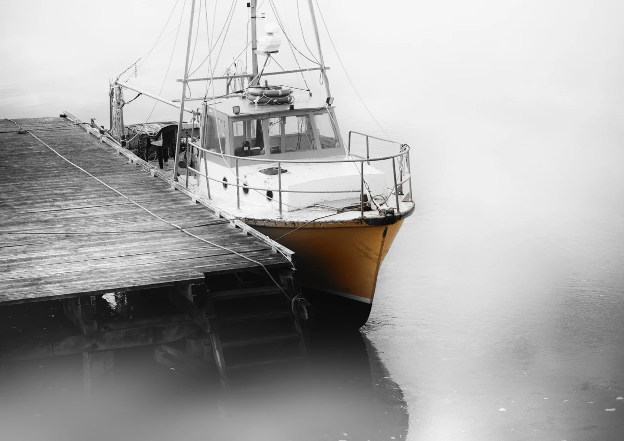Old fishing boat tied to the wharf