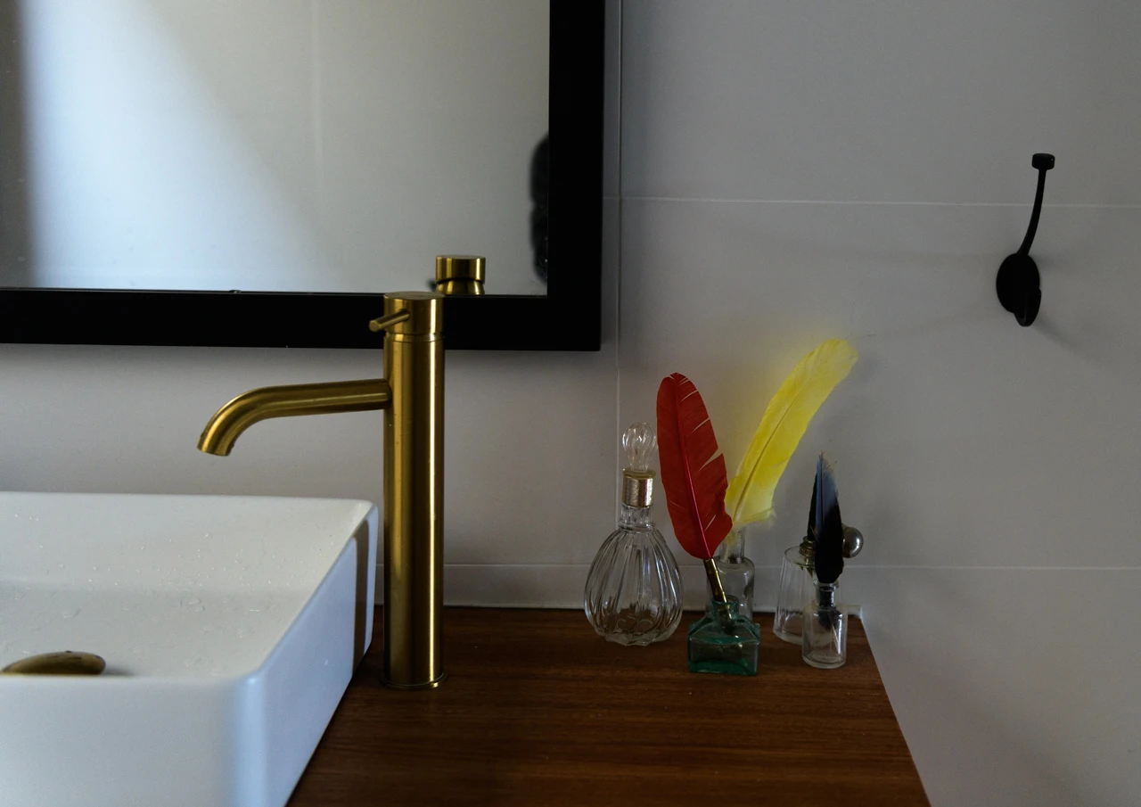 Bathroom with some feathers in old bottles