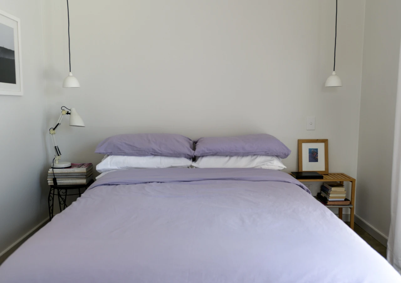 Bedroom with mauve duvet covers