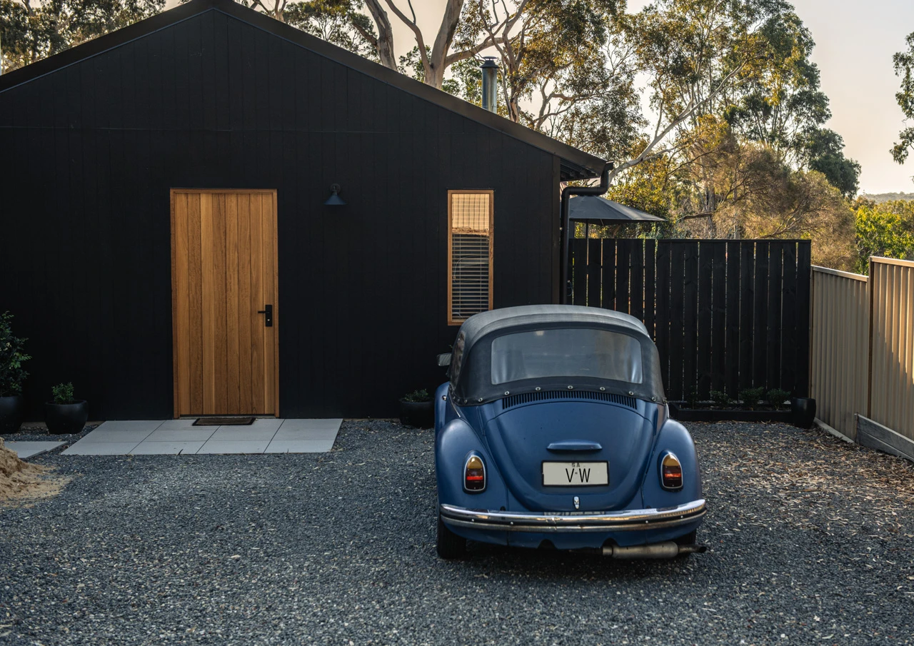 Black house with VW parked in front