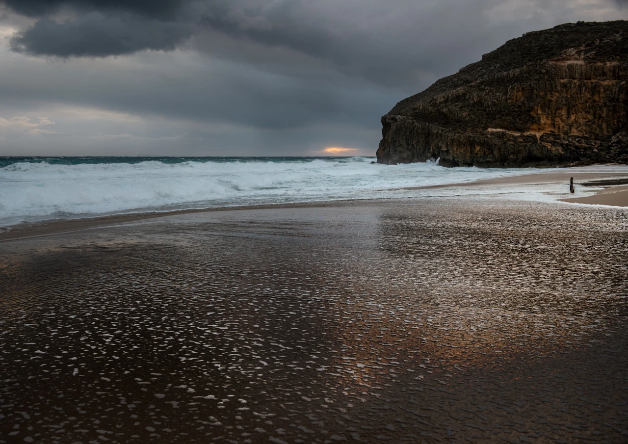 Ocean waves stream in. Ethel beach cliffs