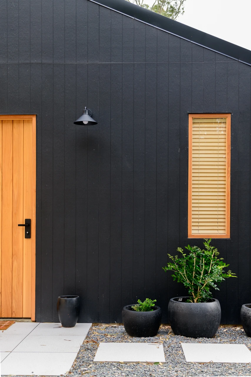 Out doors, black house and wooden front door