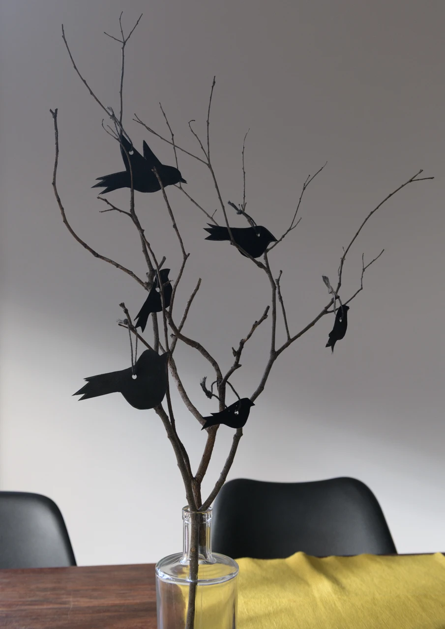 Paper black birds in my house with yellow place mat