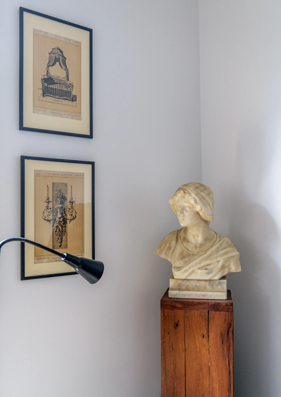 Statue and two black and white prints