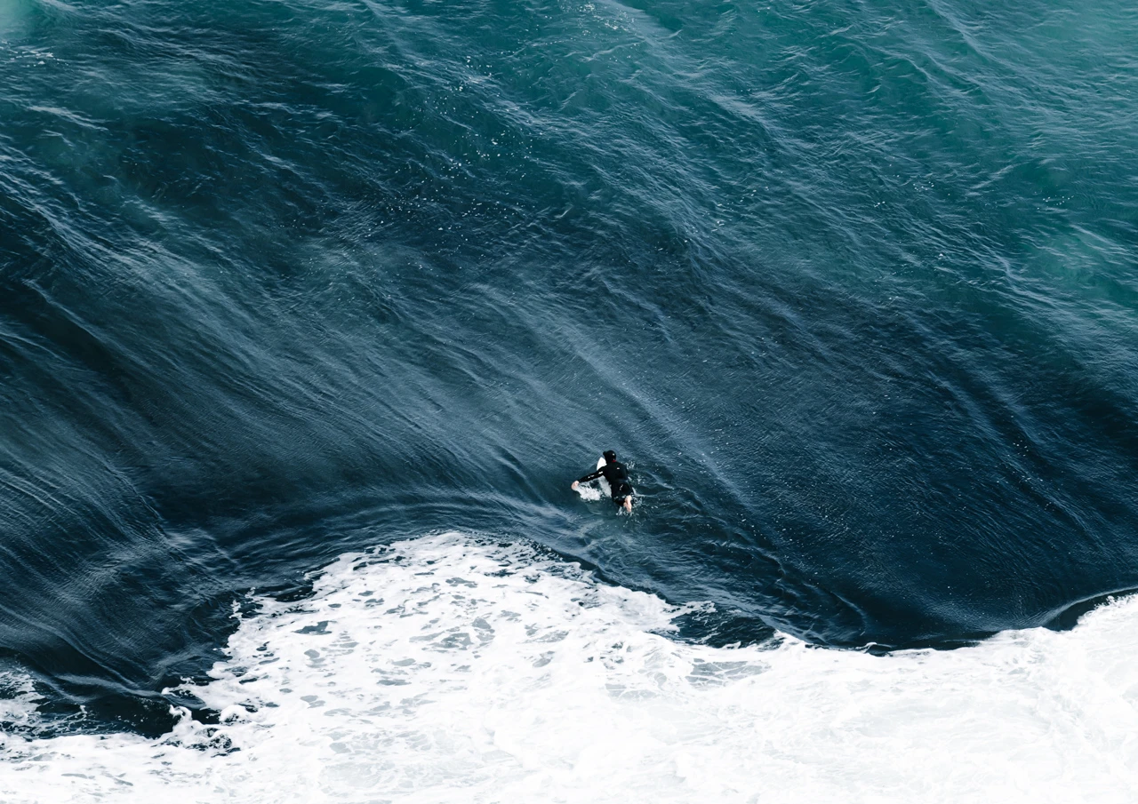 The surfer well covered in winter wet suit