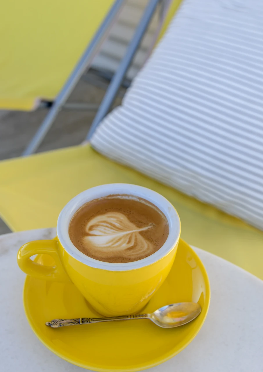 Coffee and a yellow cushion